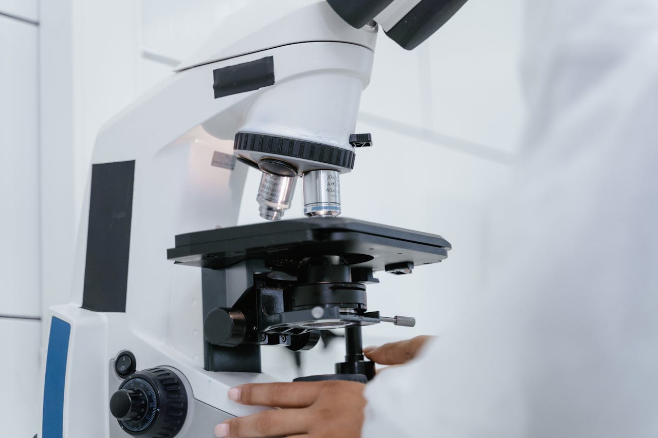 Scientist at analytical microscope in QC laboratory